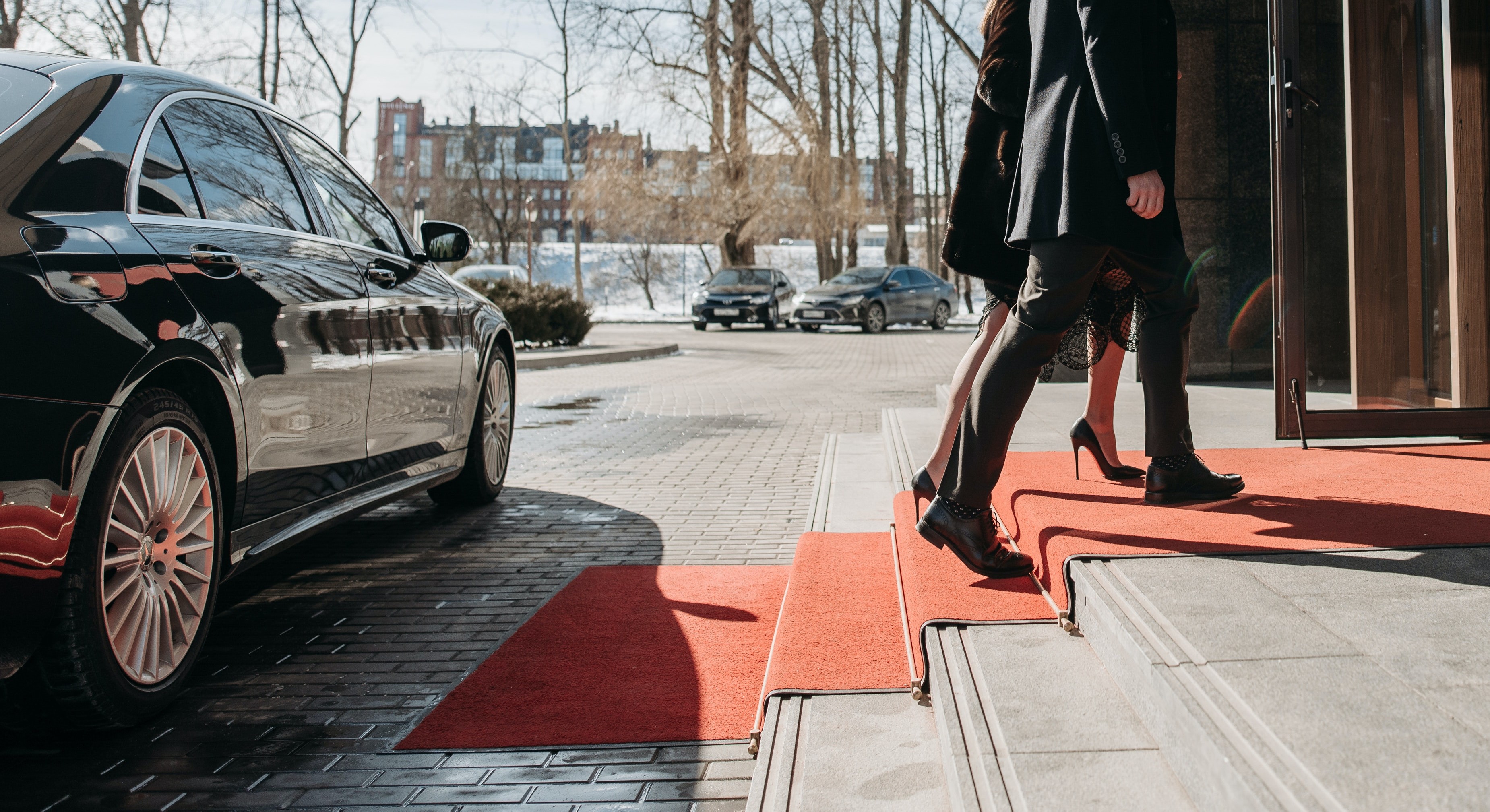 Pople exiting limousine to attend red carpet event